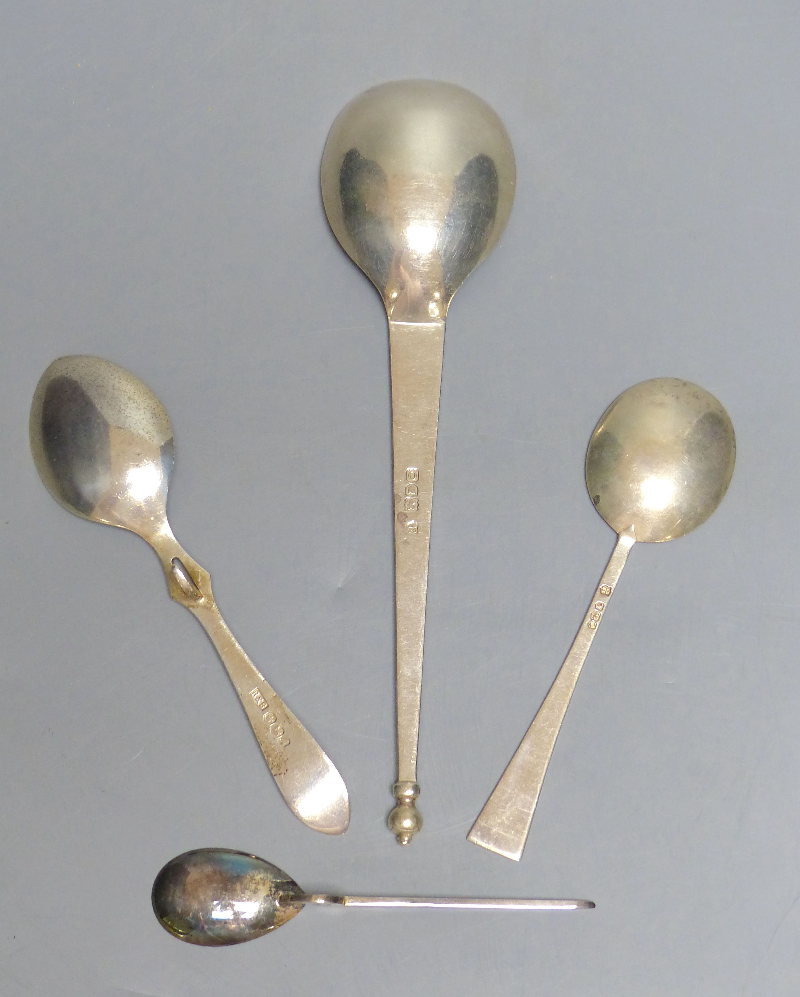 An Arts & Crafts silver spoon with oval bowl and urn finial, George Jackson & David Fullerton, London 1902 and three other spoons